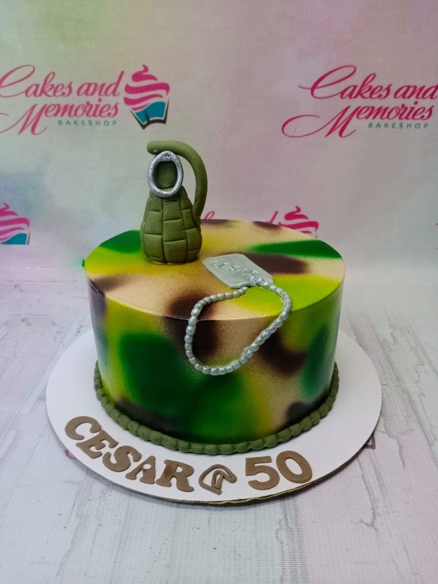 Military camouflage themed cake with a green fondant grenade and silver dog tag topper for a 50th birthday.