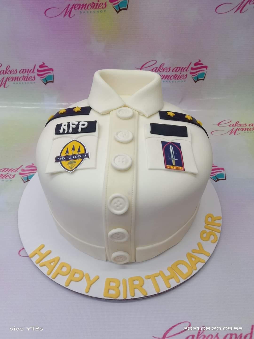 White military uniform cake with AFP and Special Forces patches, gold stars, and yellow Happy Birthday Sir message on the base.