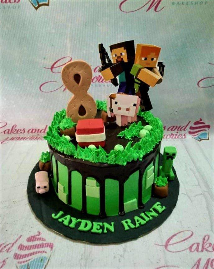 Minecraft themed birthday cake with green grass icing, chocolate drip, and character toppers for Jayden Raine's 8th birthday.