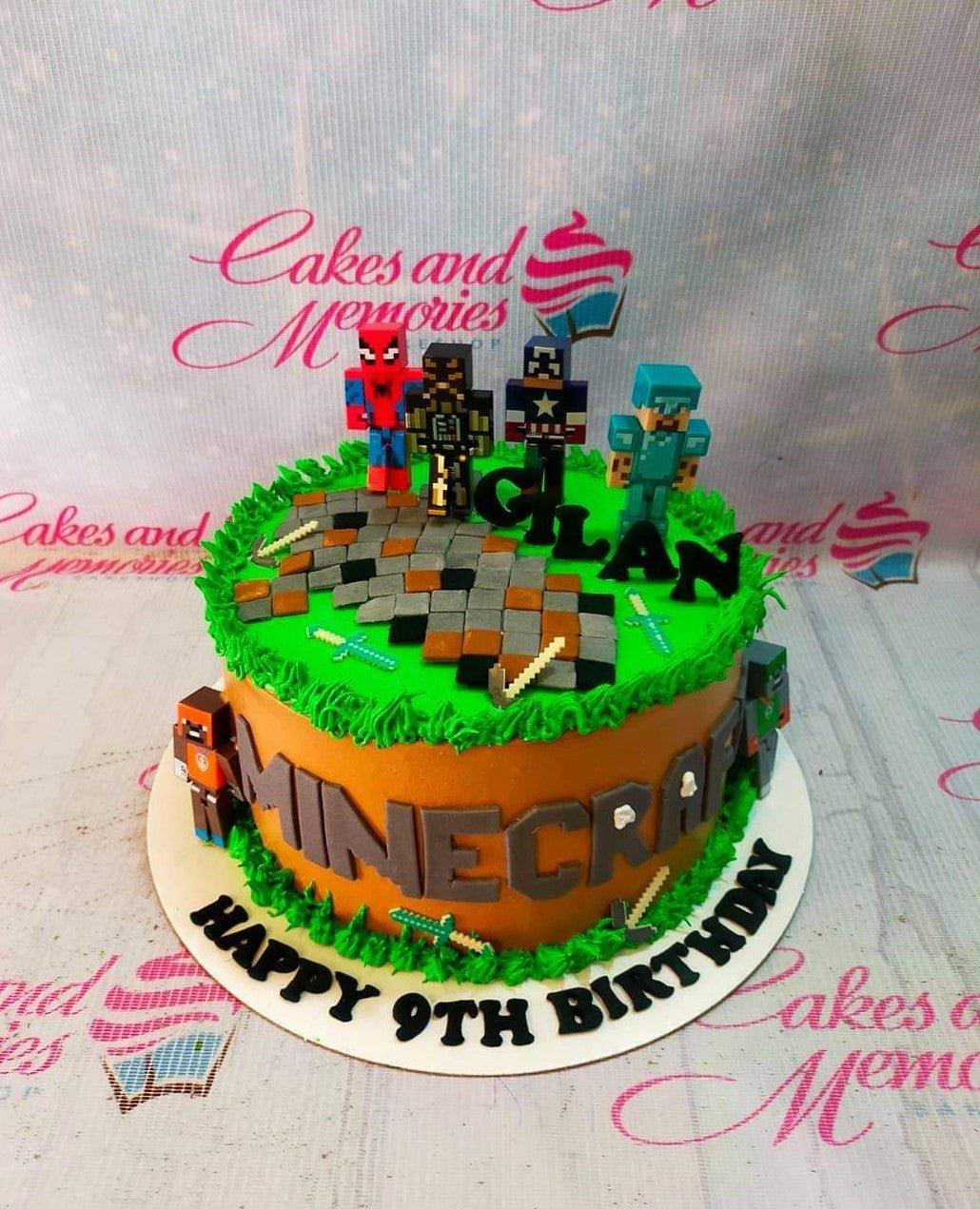 Minecraft themed birthday cake with 3D character figures, green grass icing, and a stone path design.