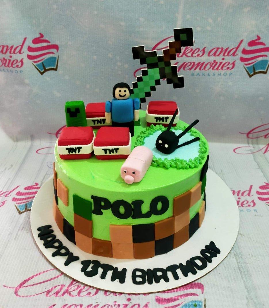 Minecraft themed birthday cake with green icing, TNT blocks, a pixelated sword, and a fondant character figure for Polo's 13th birthday.