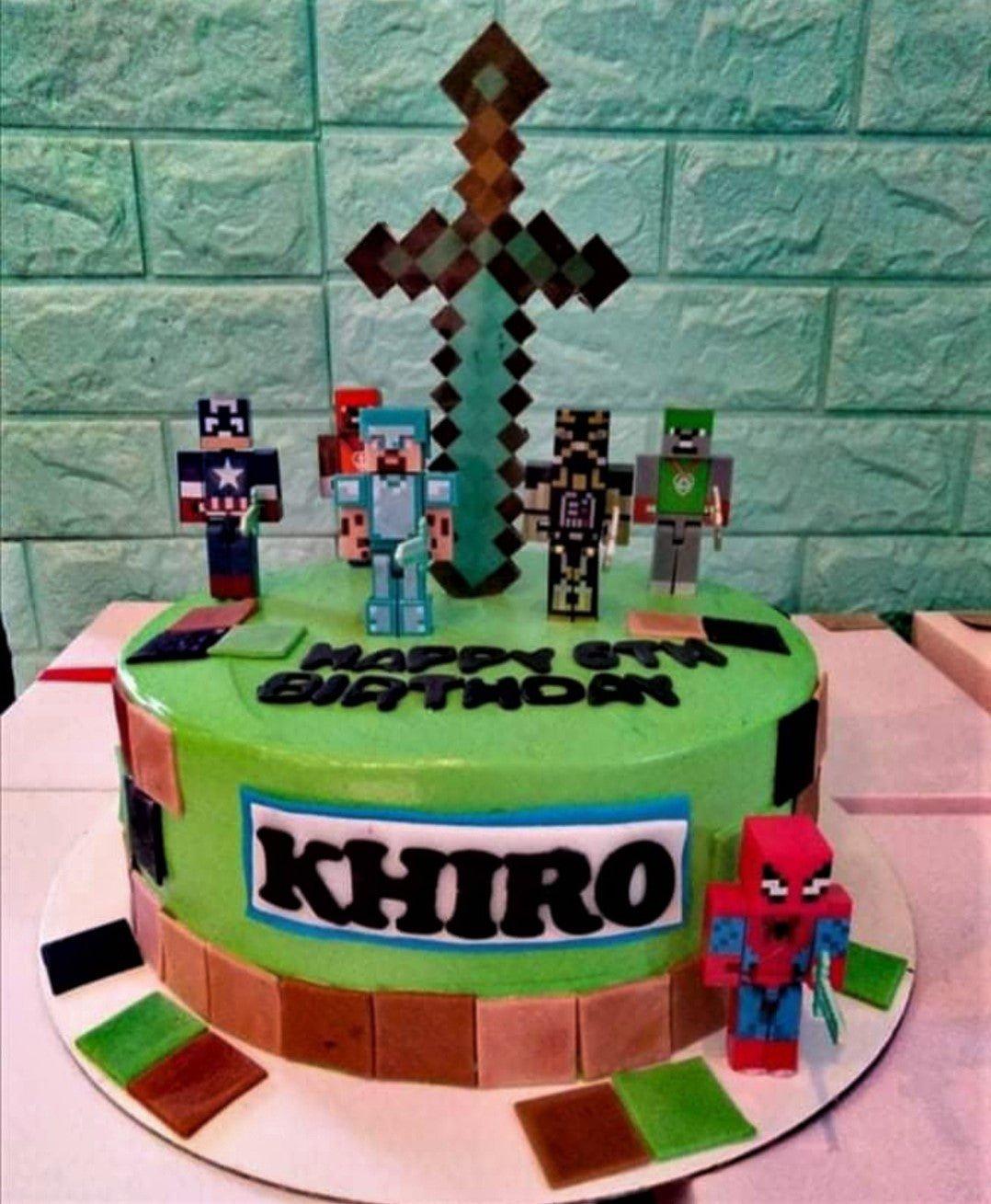 Minecraft themed green birthday cake with pixelated character printouts, a large sword topper, and brown fondant squares.