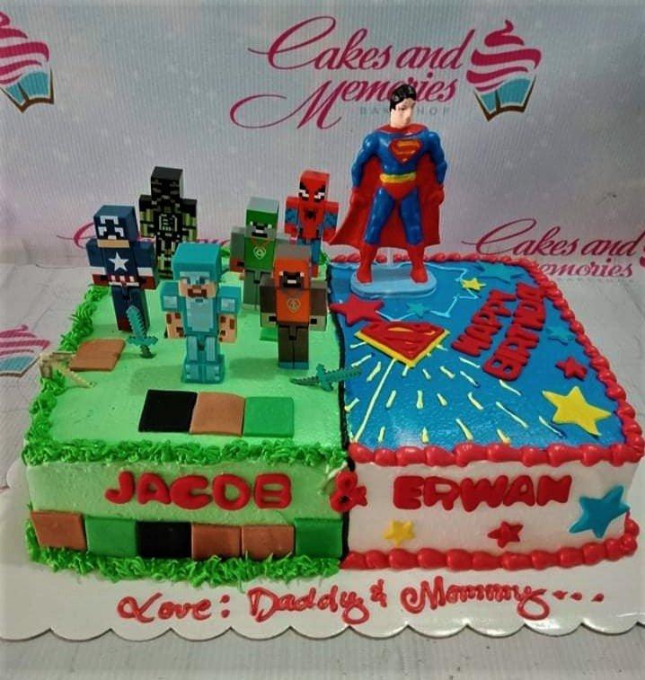 Split-themed rectangle cake featuring Minecraft and Superman designs with character toppers and personalized names Jacob and Erwan.
