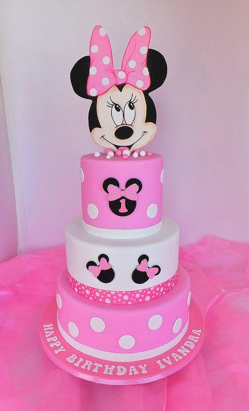 Pink and white 3-tier Minnie Mouse themed fondant cake with polka dots and character toppers