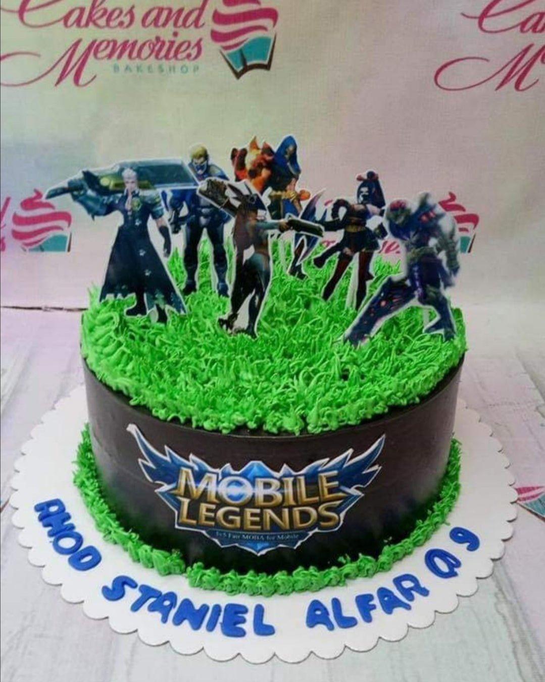 Mobile Legends themed chocolate cake with green grass icing and character printouts