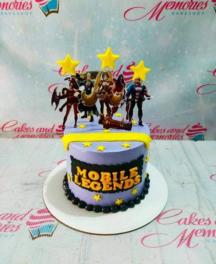 Mobile Legends themed purple cake with character printouts, yellow stars, and a black beaded border.