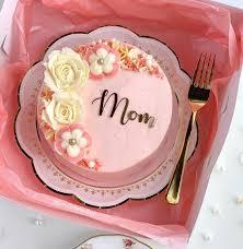 Pink bento cake with white and pink icing flowers and a black Mom message