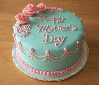Teal fondant cake for Mother's Day with pink icing roses and elegant piped scrollwork borders.