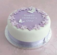 Elegant lavender and white Mother's Day cake with a ring of fondant flowers and delicate white butterflies.