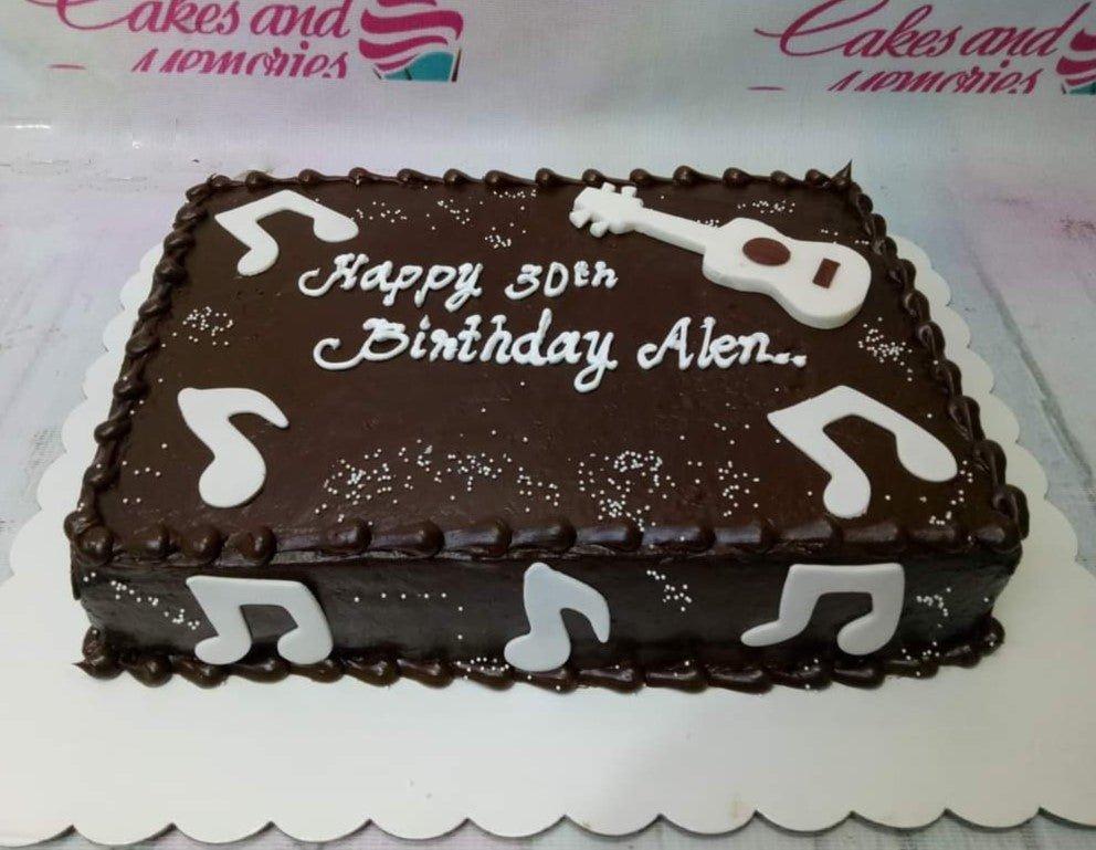 Rectangle chocolate birthday cake with white fondant music notes and a guitar topper for Alen's 30th birthday.