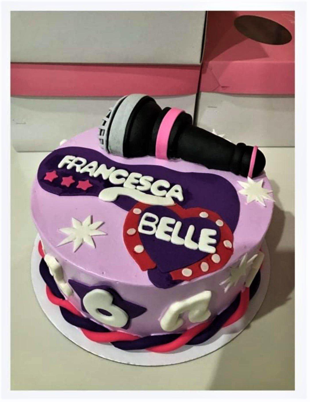 Purple and pink music themed cake with a 3D fondant microphone, stars, and musical notes for Francesca Belle's 6th birthday.
