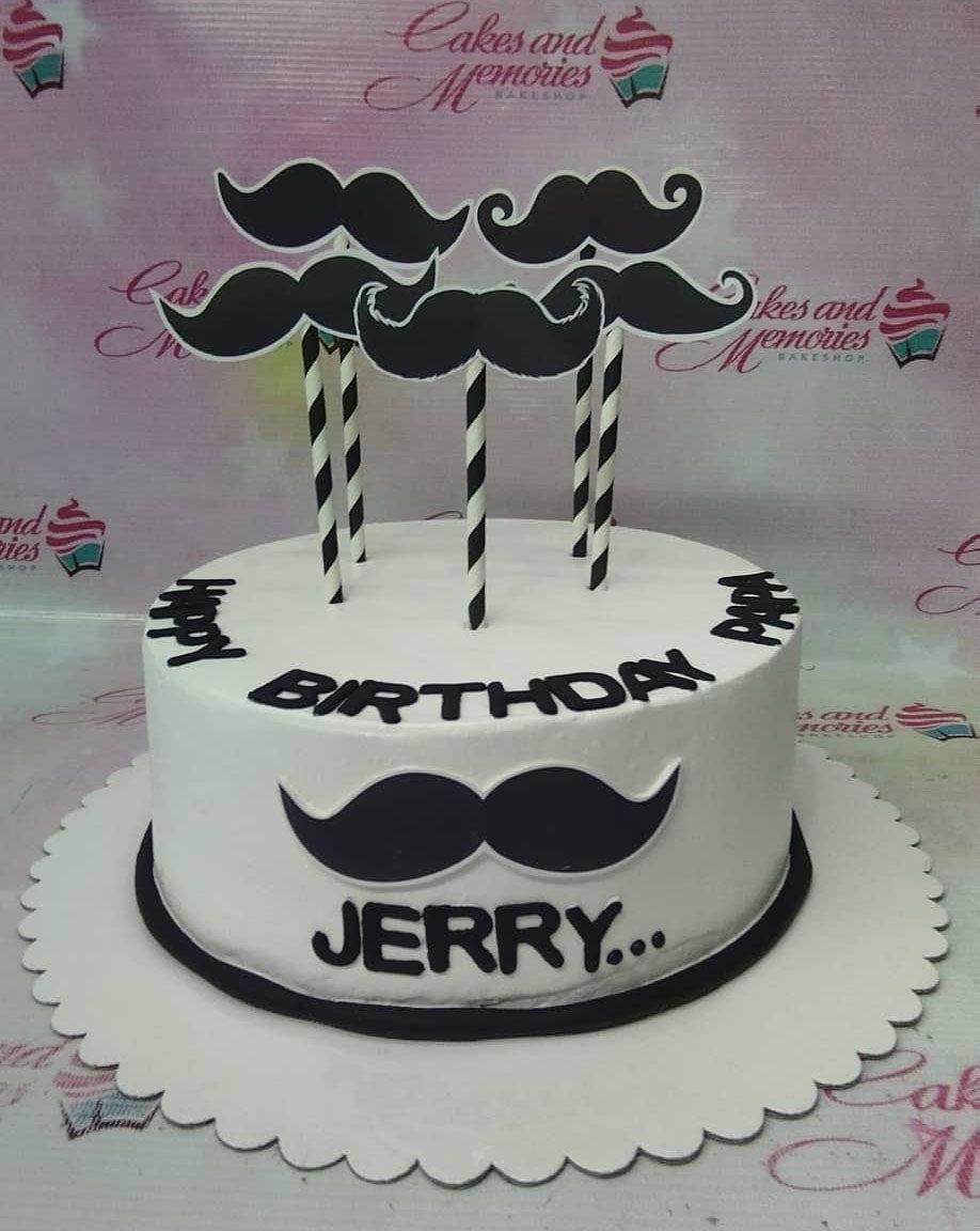 White minimalist mustache birthday cake for Papa Jerry with black mustache printouts and black icing text.