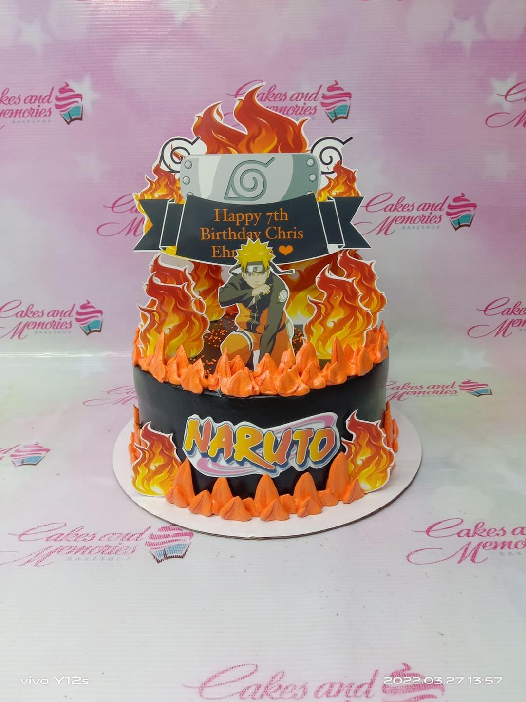 Naruto themed birthday cake with black icing, orange flame decorations, and character printouts for Chris Ehr's 7th birthday.