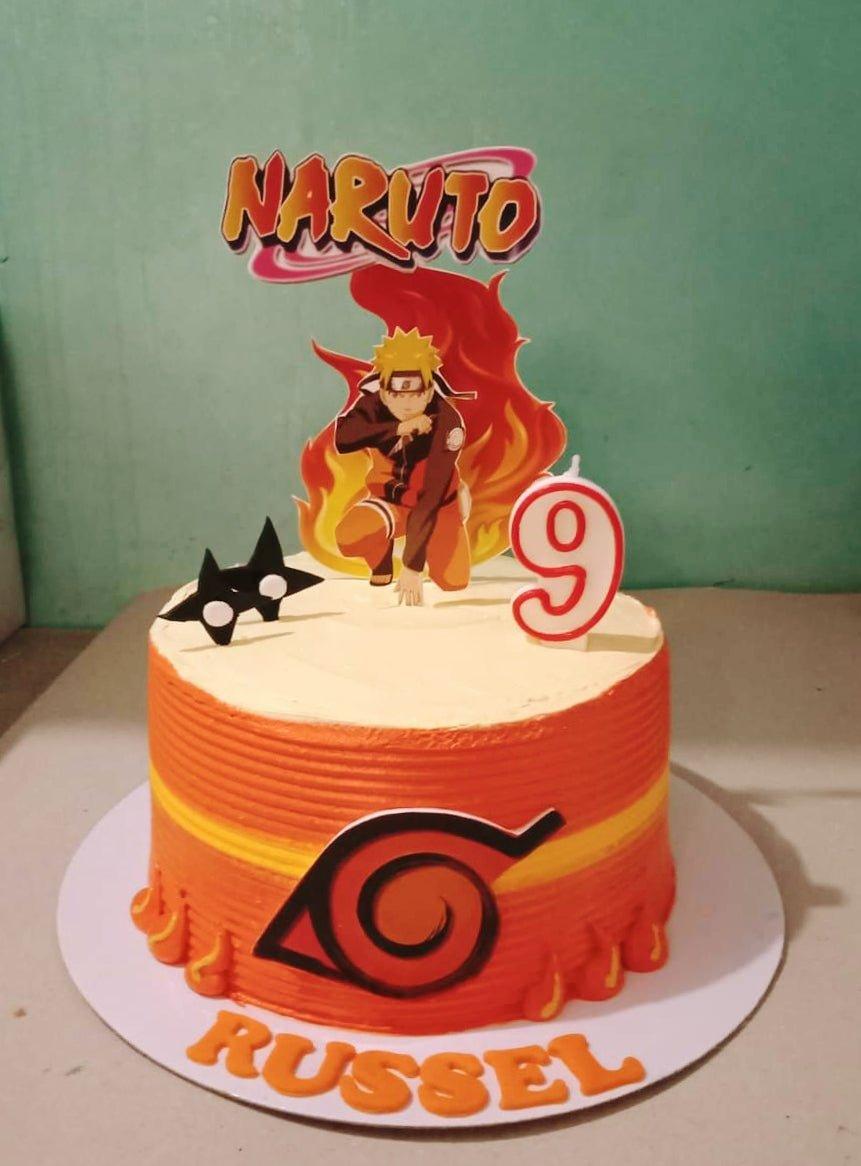 Naruto themed orange and yellow birthday cake with character printouts and a number 9 candle.