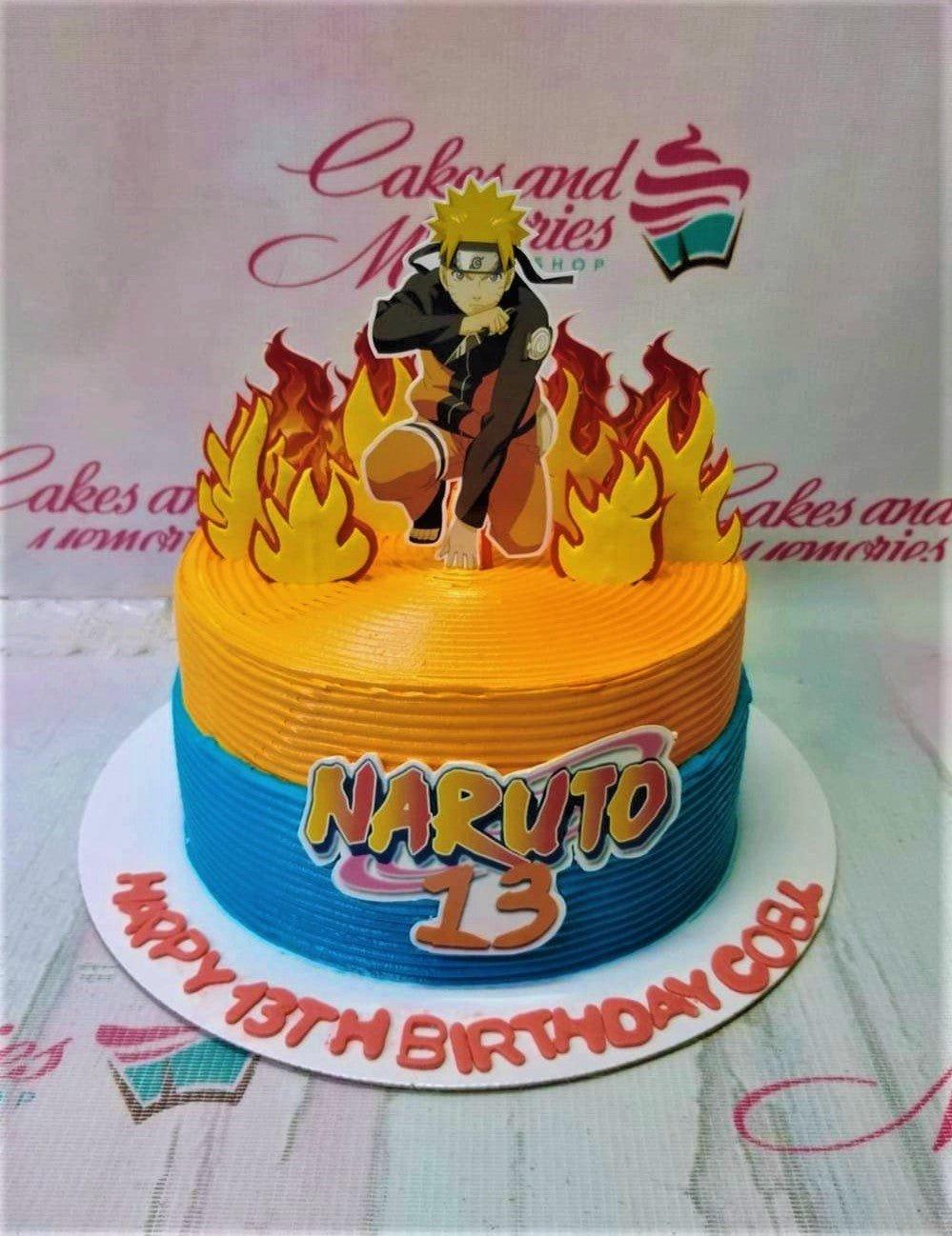 Naruto themed birthday cake with orange and blue horizontal textured icing, flame toppers, and a Naruto character printout.