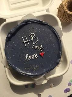 Navy blue bento cake with white piped icing message 'HB my love' and a small red heart decoration.
