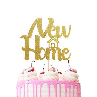Pink drip cake with white icing swirls, cherries, and a gold glitter New Home topper.
