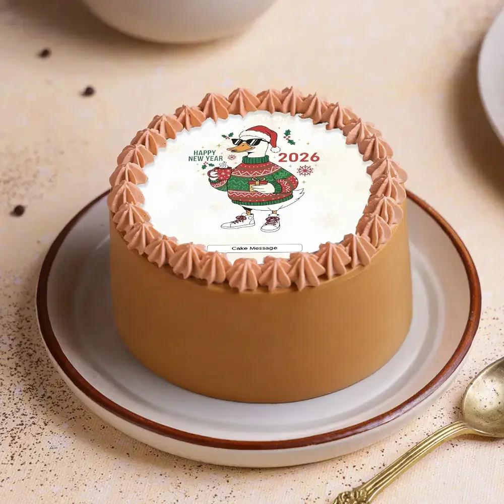 Bento cake with brown icing, a festive duck printout wearing a Christmas sweater and Santa hat, and piped icing borders.