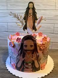 A pink 1 Tier cake featuring a Nezuko character print and edible pink cherry blossom and gold leaf decorations.