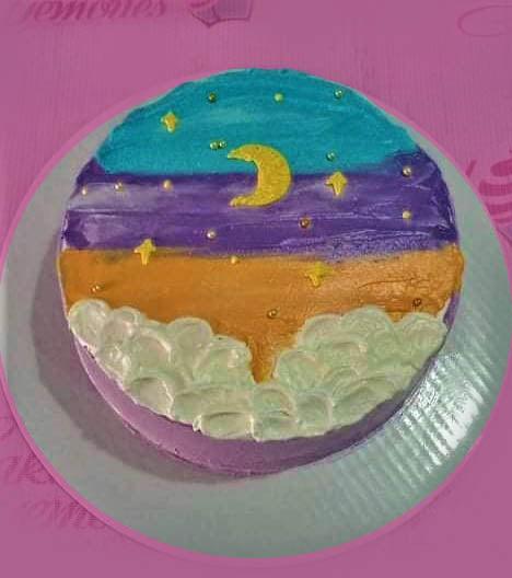 Bento cake with a hand-painted night sky scene featuring a yellow crescent moon, gold stars, and white fluffy clouds.