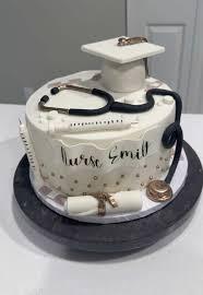 White fondant nurse graduation cake with a black stethoscope, graduation cap, syringe, and diploma toppers.