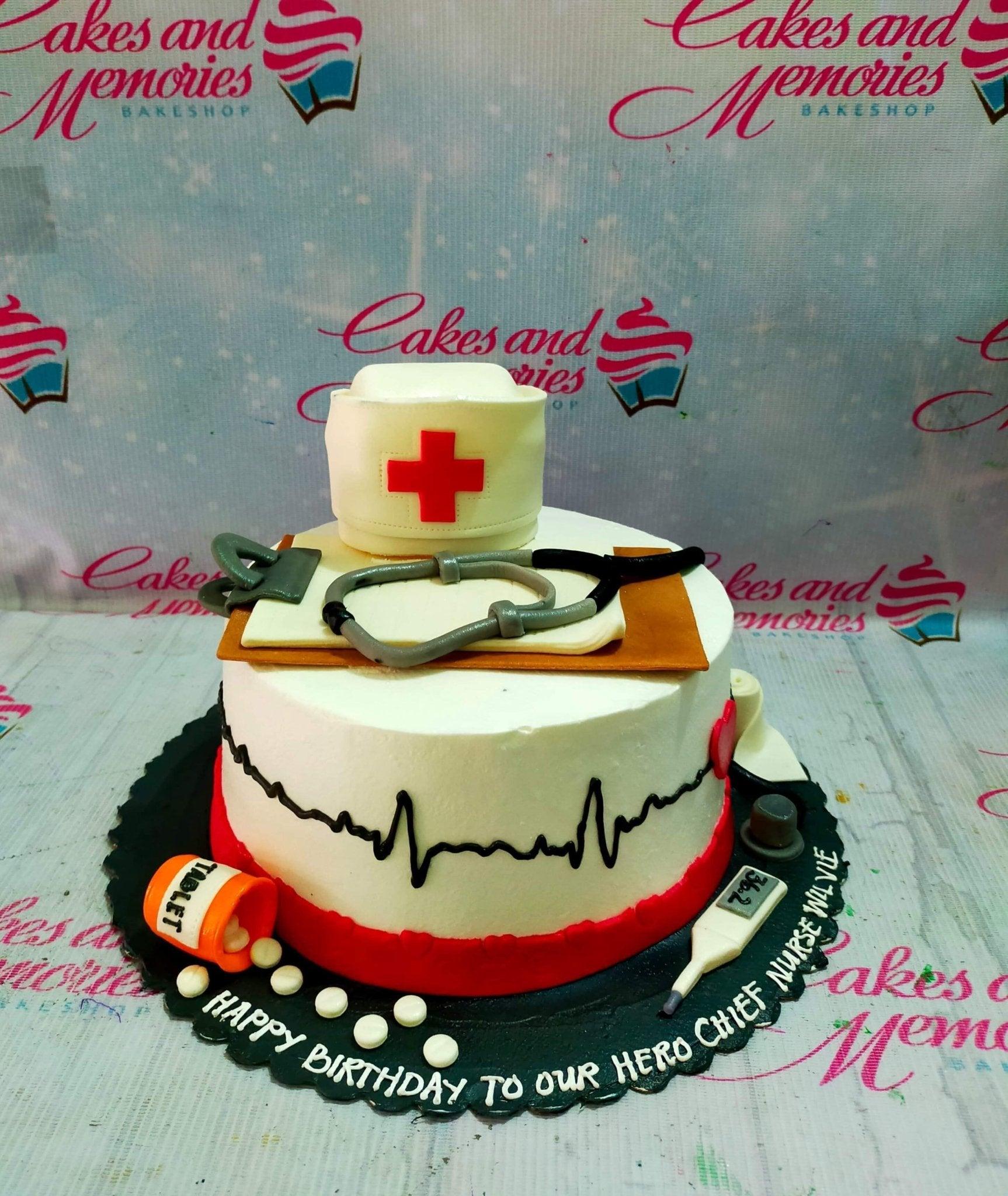 White medical themed cake with a nurse cap, stethoscope, clipboard, and heartbeat line for a chief nurse's birthday.