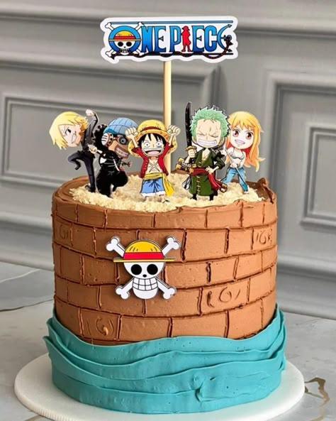 One Piece themed birthday cake with brown brick-textured icing, blue wave base, and character toppers including Luffy, Zoro, and Nami.