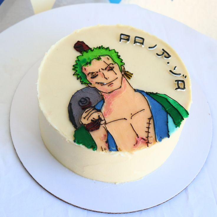 White round cake featuring a hand-painted edible icing illustration of Roronoa Zoro from One Piece with Japanese text.