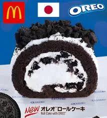 Oreo chocolate roll cake with white cream filling and crushed Oreo cookie topping.