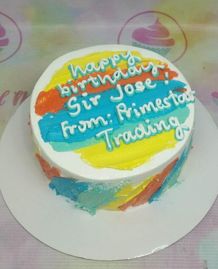 A white minimalist cake with colorful palette knife icing strokes in yellow, orange, and teal, featuring a birthday message for Sir Jose.