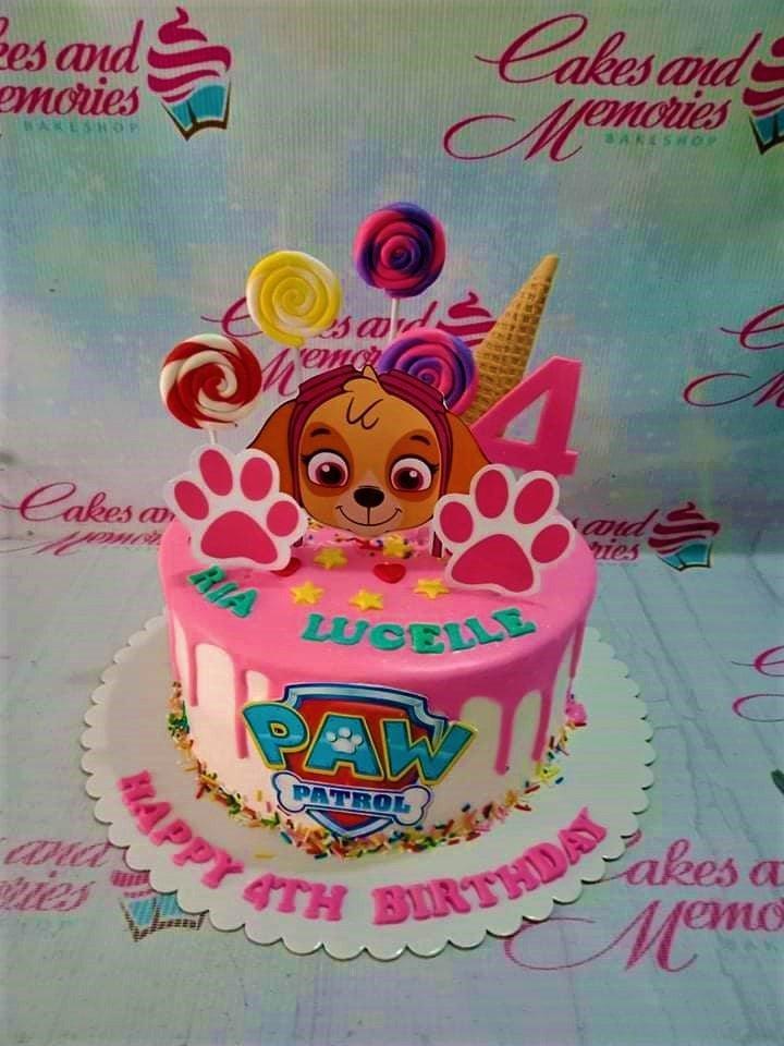 Pink Paw Patrol Skye themed birthday cake with pink drip, lollipops, and a large Skye character topper.