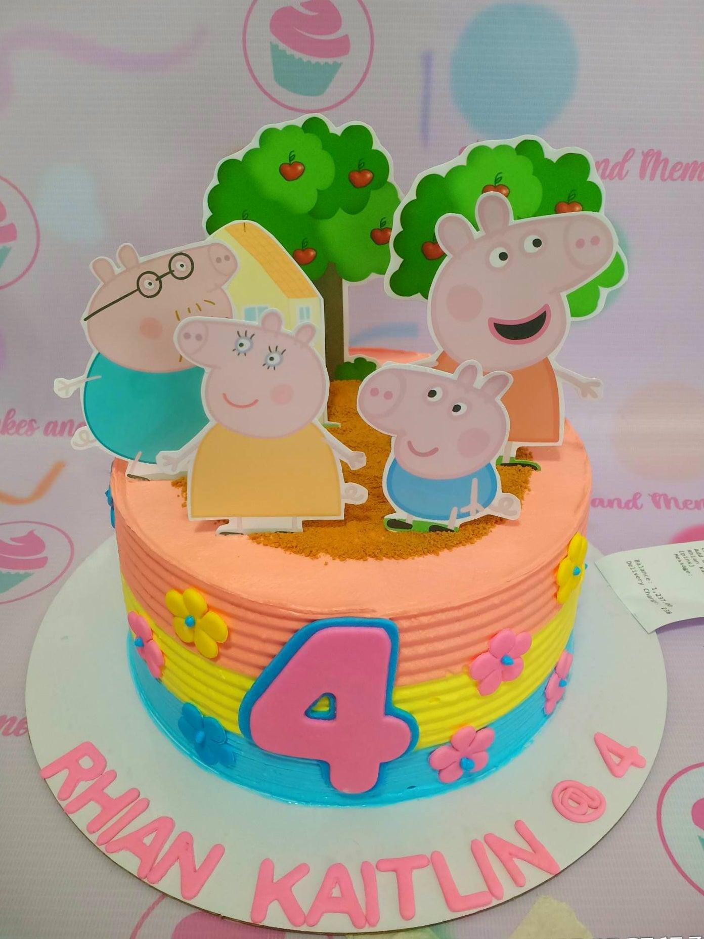 Peppa Pig themed birthday cake with colorful horizontal icing stripes in pink, yellow, and blue, featuring Peppa Pig family printout toppers.