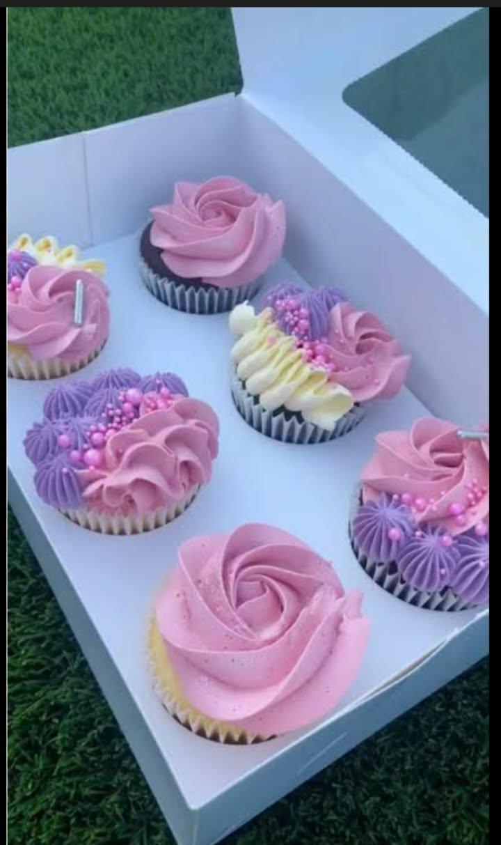 Pink and purple cupcakes with buttercream icing.
