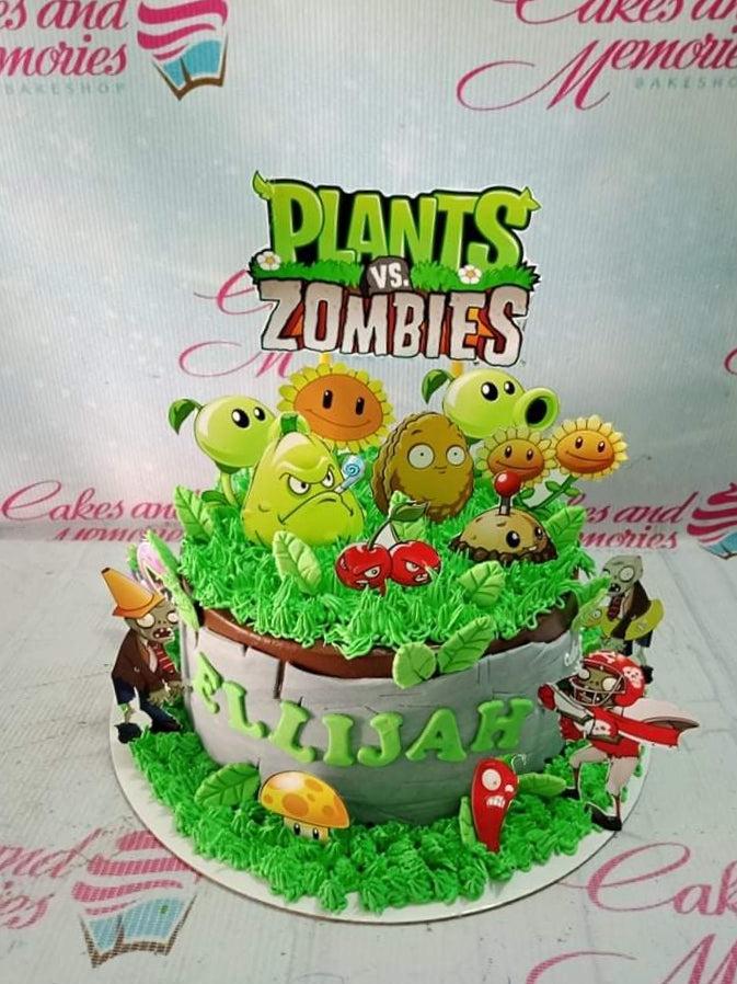 Plants vs Zombies themed birthday cake with green grass icing, stone wall design, and character printouts for Ellijah.