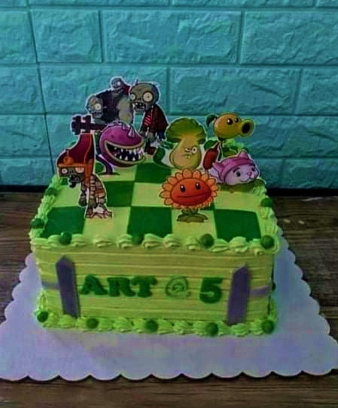 Square Plants vs Zombies themed birthday cake with green checkered icing and character printouts.