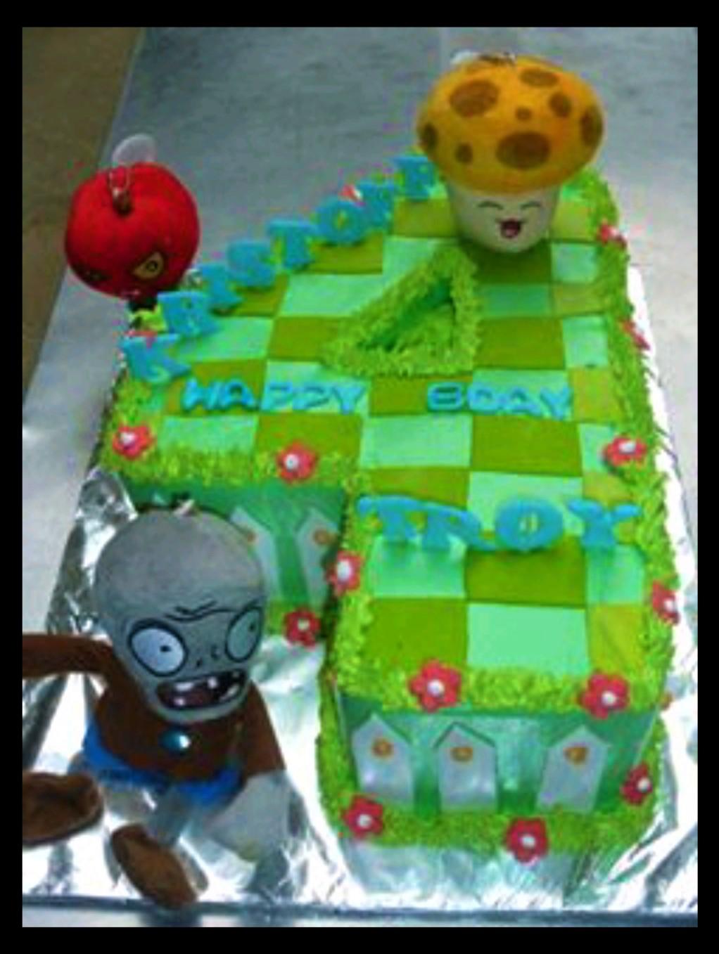Plants vs Zombies themed number 4 shaped cake with a checkerboard green pattern, featuring a zombie and mushroom toppers.