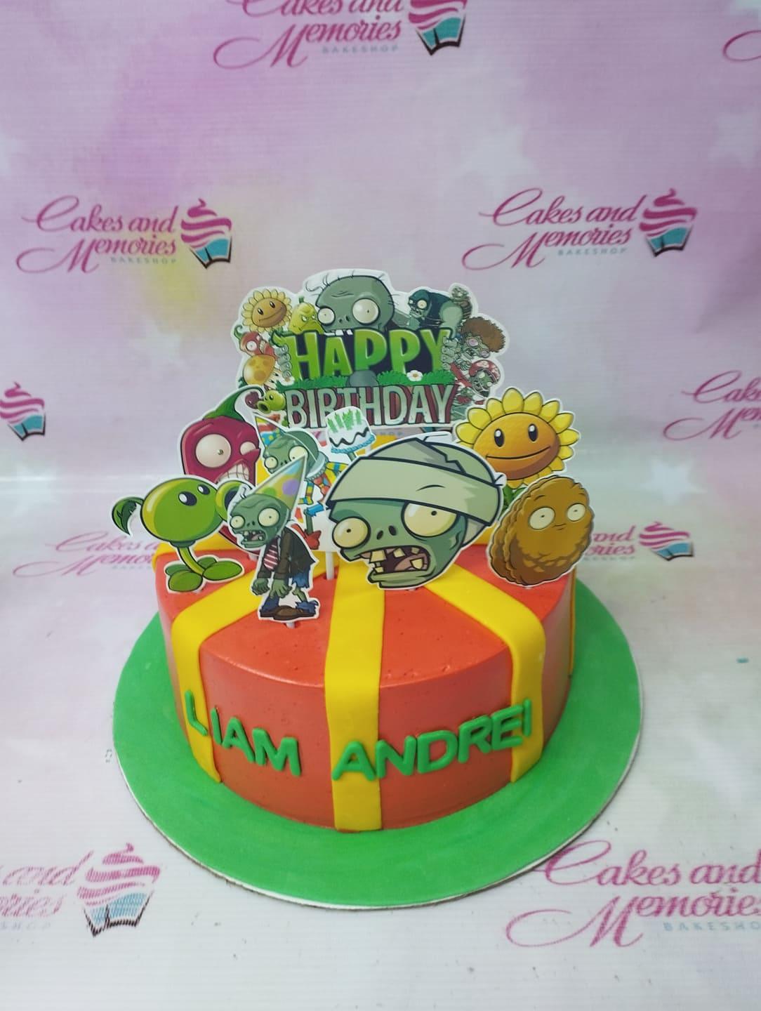 Plants vs. Zombies themed birthday cake with red icing, yellow fondant stripes, and character printouts for Liam Andrei.