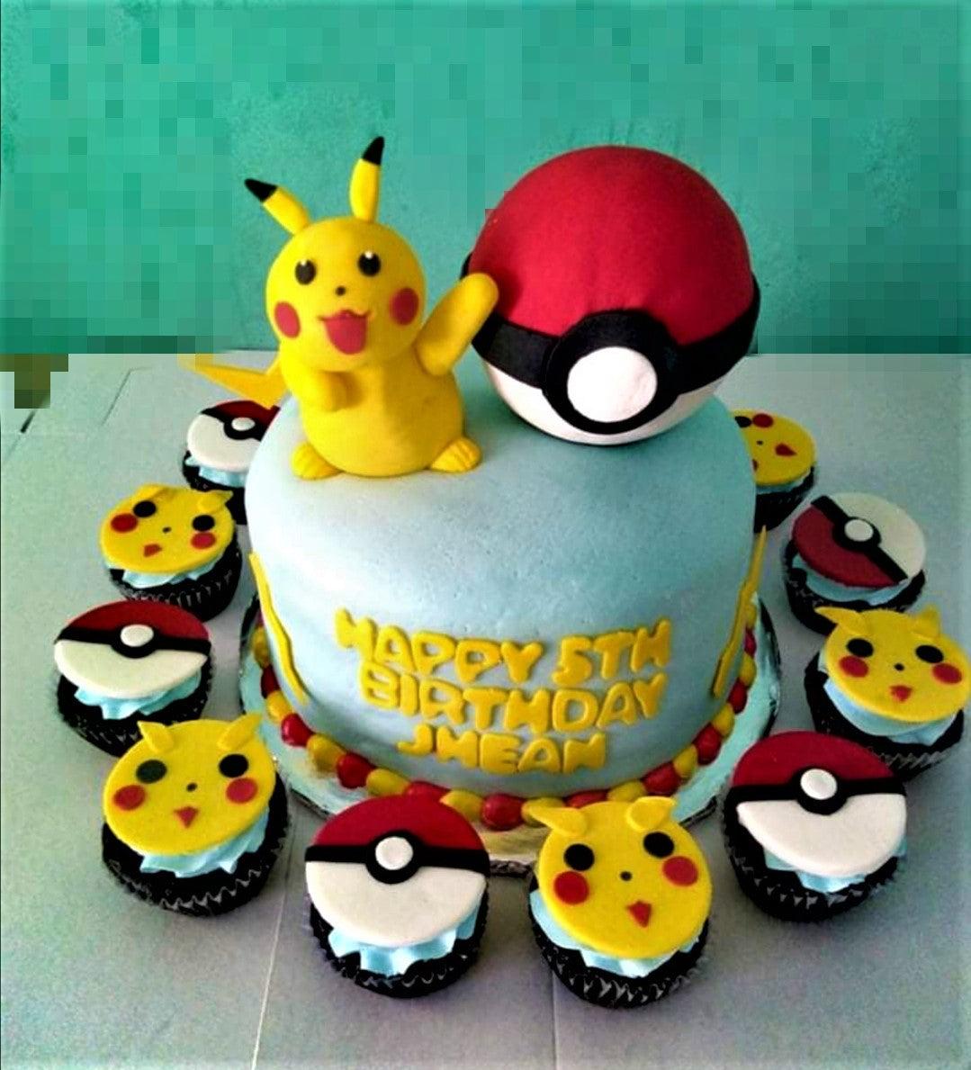 Light blue fondant Pokemon cake featuring a 3D Pikachu and Pokeball topper with matching Pikachu and Pokeball cupcakes.