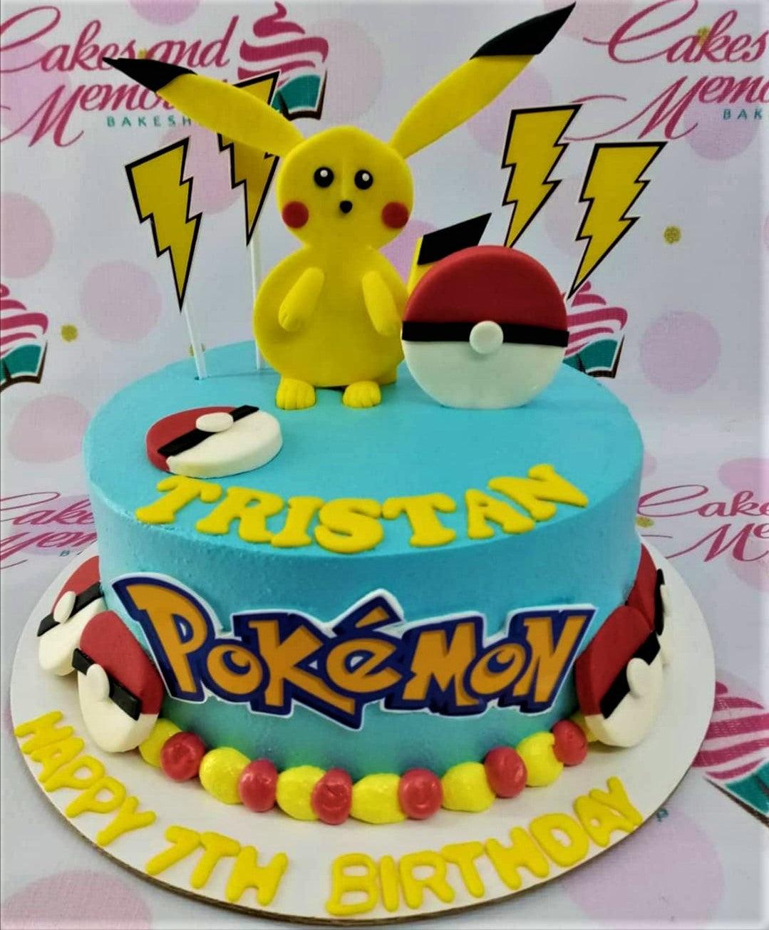Light blue Pokemon themed birthday cake for Tristan featuring a 3D Pikachu figure, Pokeballs, and yellow lightning bolts.