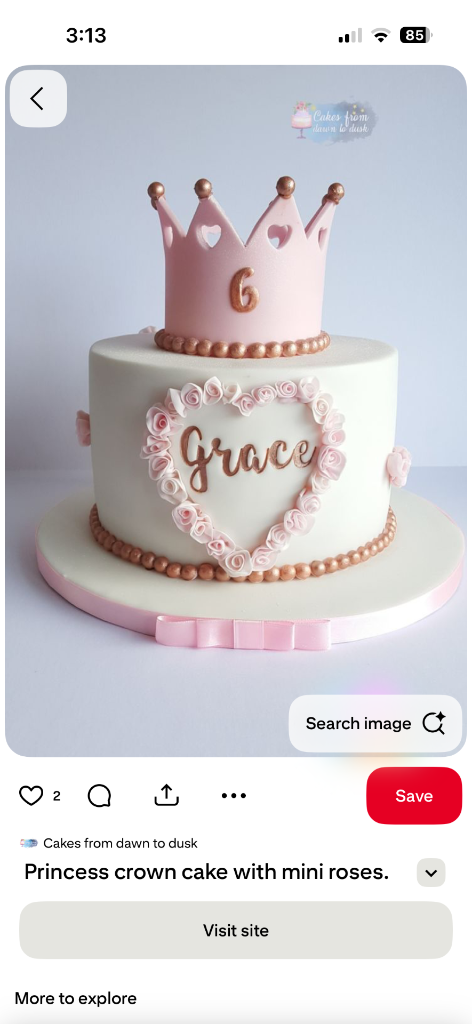 Elegant white fondant princess cake with a pink crown topper, gold bead borders, and a floral heart frame around the name Grace.