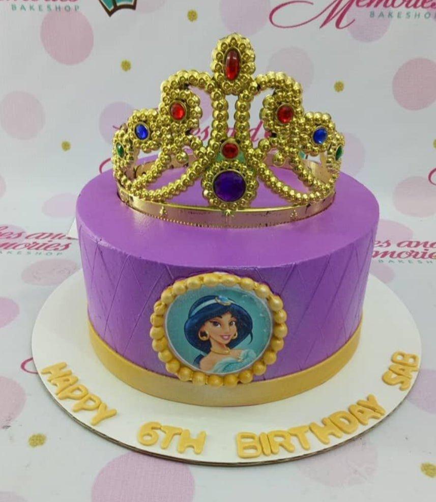 Purple Princess Jasmine cake with a large gold rhinestone crown and a circular Jasmine printout on the side.