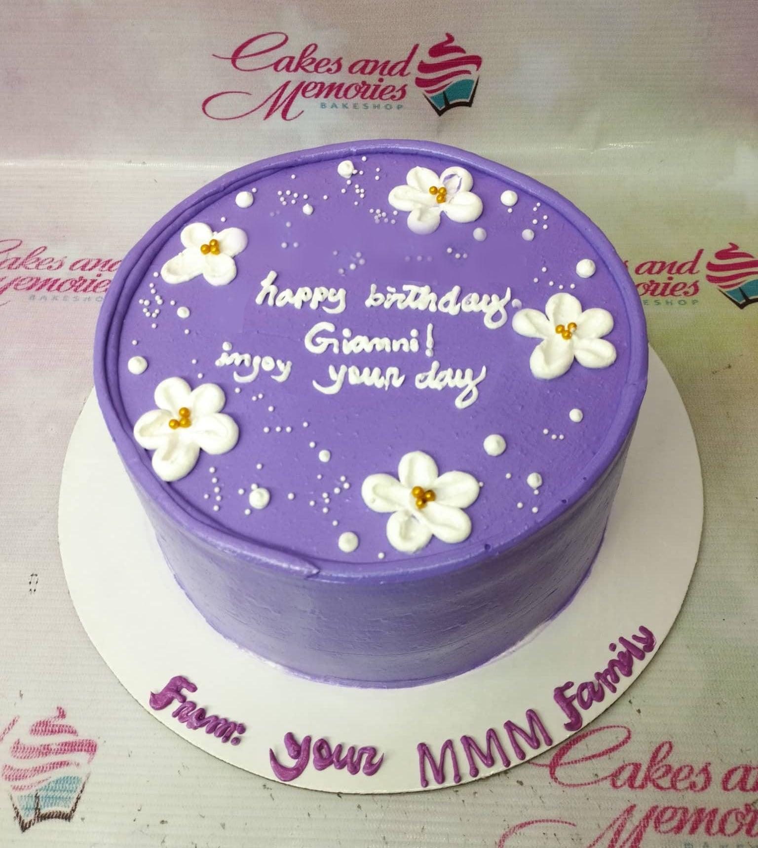 Purple minimalist birthday cake with white icing flowers and gold pearls for Gianni.
