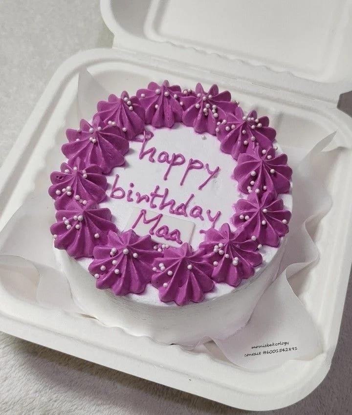 White bento cake with purple icing rosettes and white pearl sprinkles featuring a Happy Birthday Maa message.