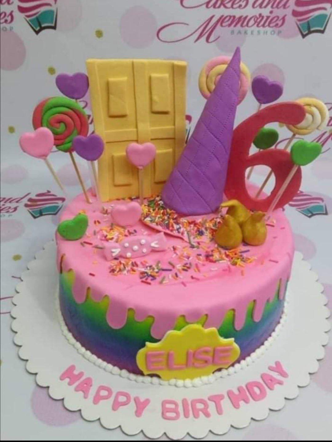Rainbow drip birthday cake with a yellow door, purple cone, and pink heart toppers for a 6th birthday.