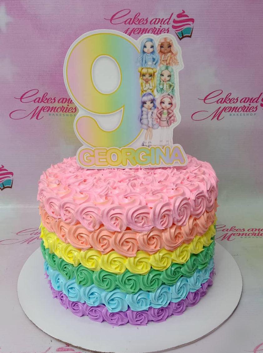 Rainbow rosette cake with a large number 9 and Rainbow High character printout topper for Georgina's 9th birthday.