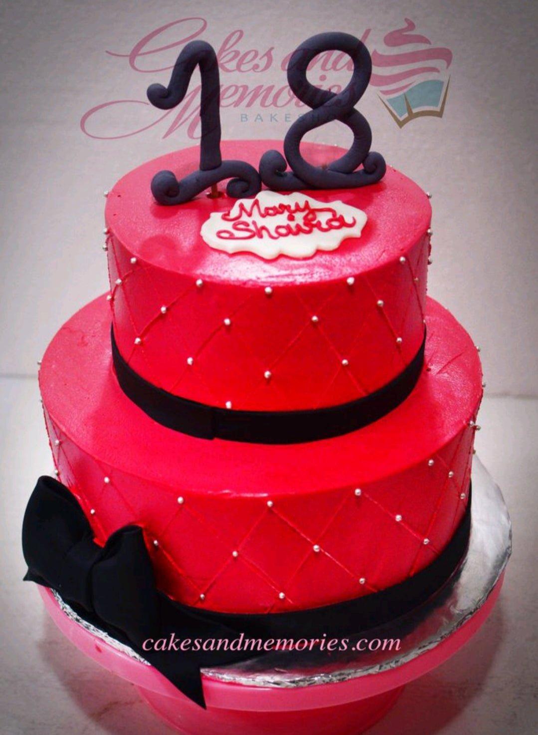 Red 2-tier fondant cake with black ribbon accents, quilted pattern with silver pearls, and a large black number 18 topper.