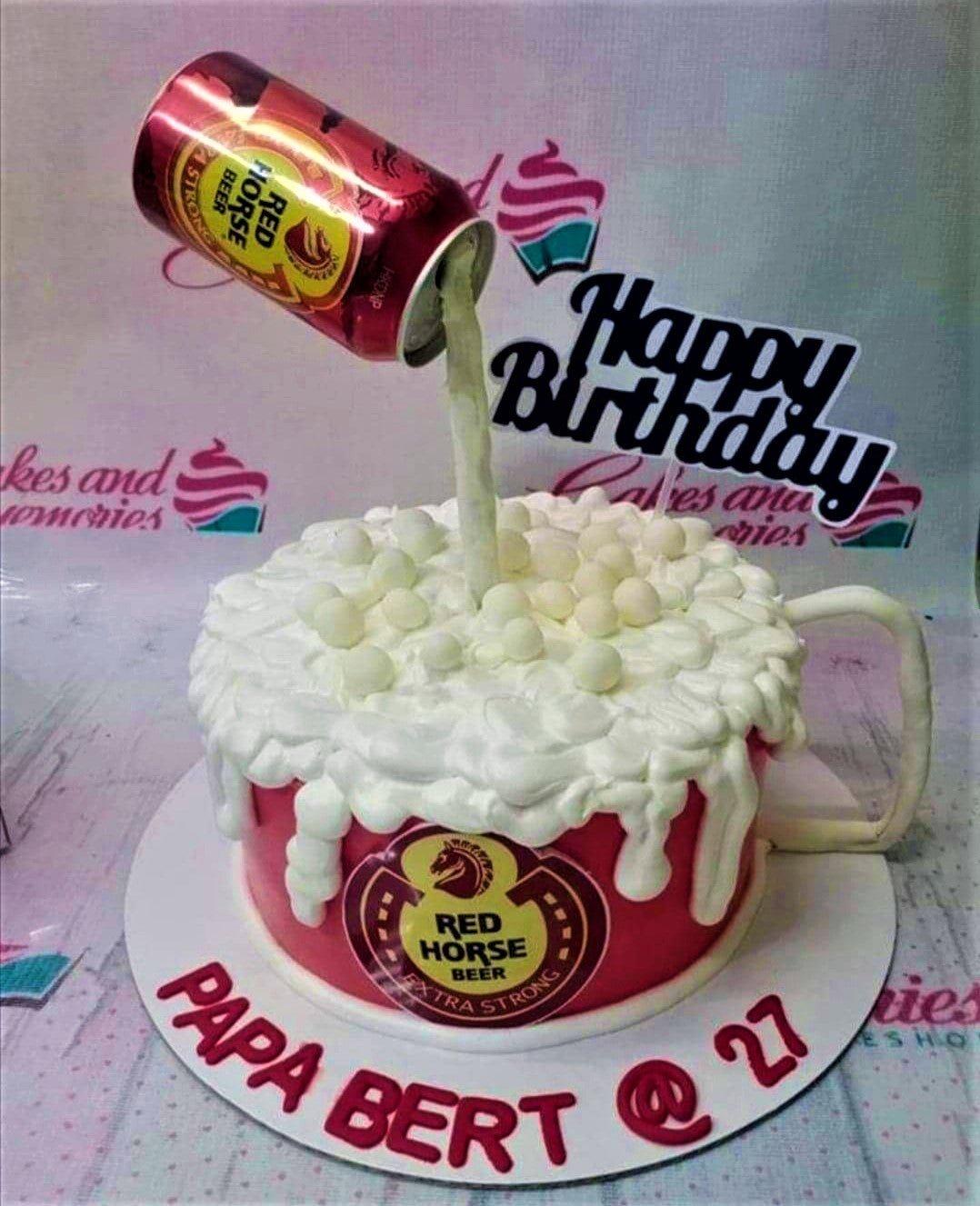 Red Horse beer themed birthday cake shaped like a mug with a pouring beer can topper and white icing foam.