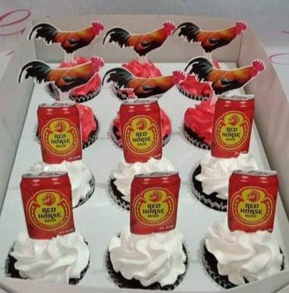 Red Horse beer and rooster themed cupcakes with red and white icing swirls in a white box.