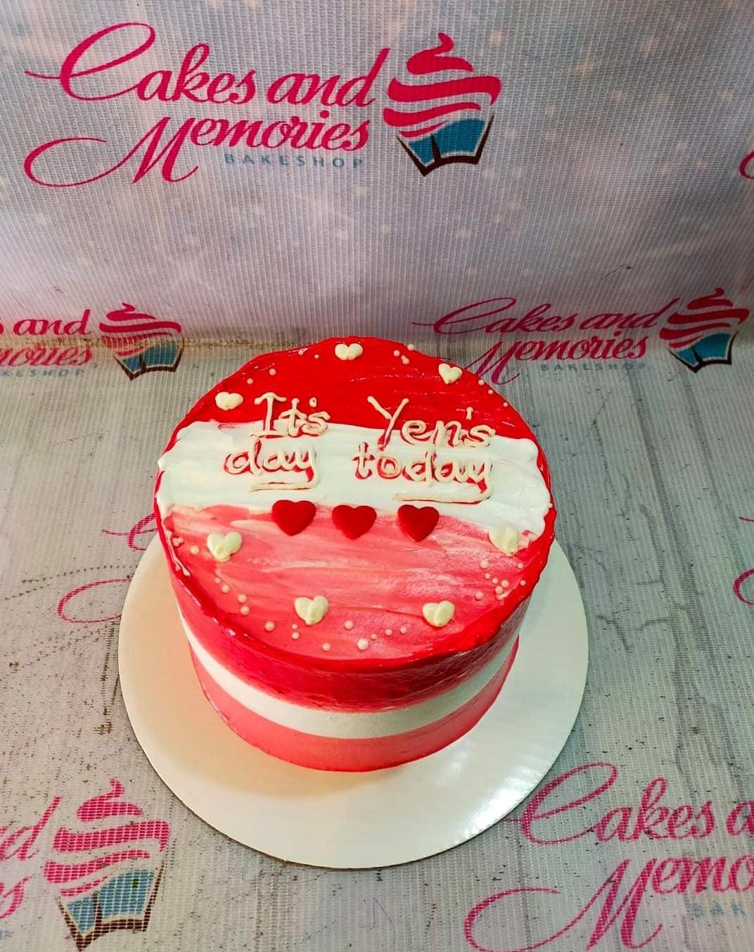 Red and white minimalist bento cake with heart decorations and piped icing message