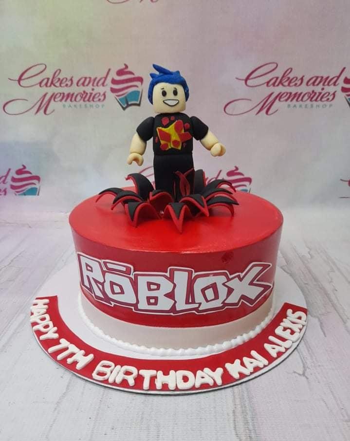Red Roblox themed birthday cake with a 3D fondant character topper and a large Roblox logo on the side.